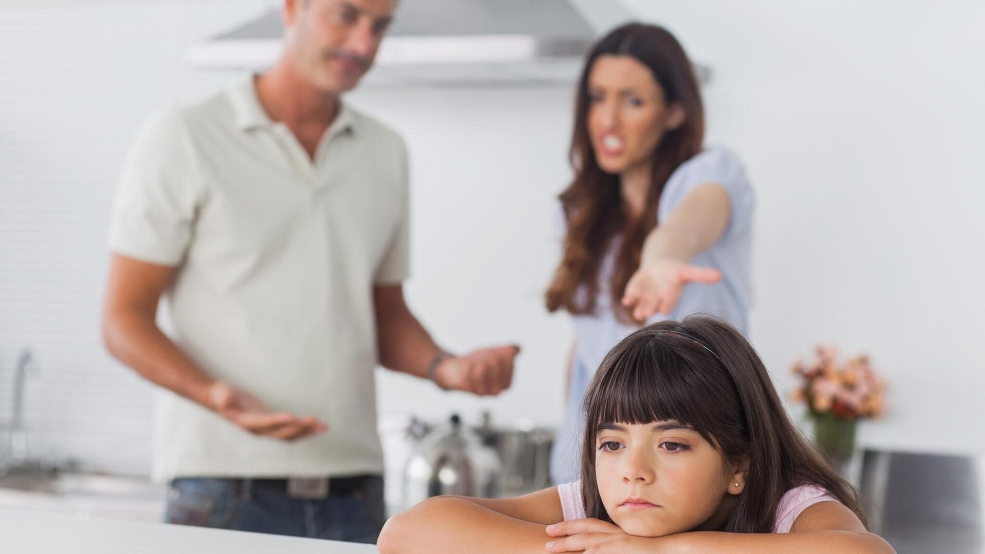 couple having dispute in front of their upset daughter