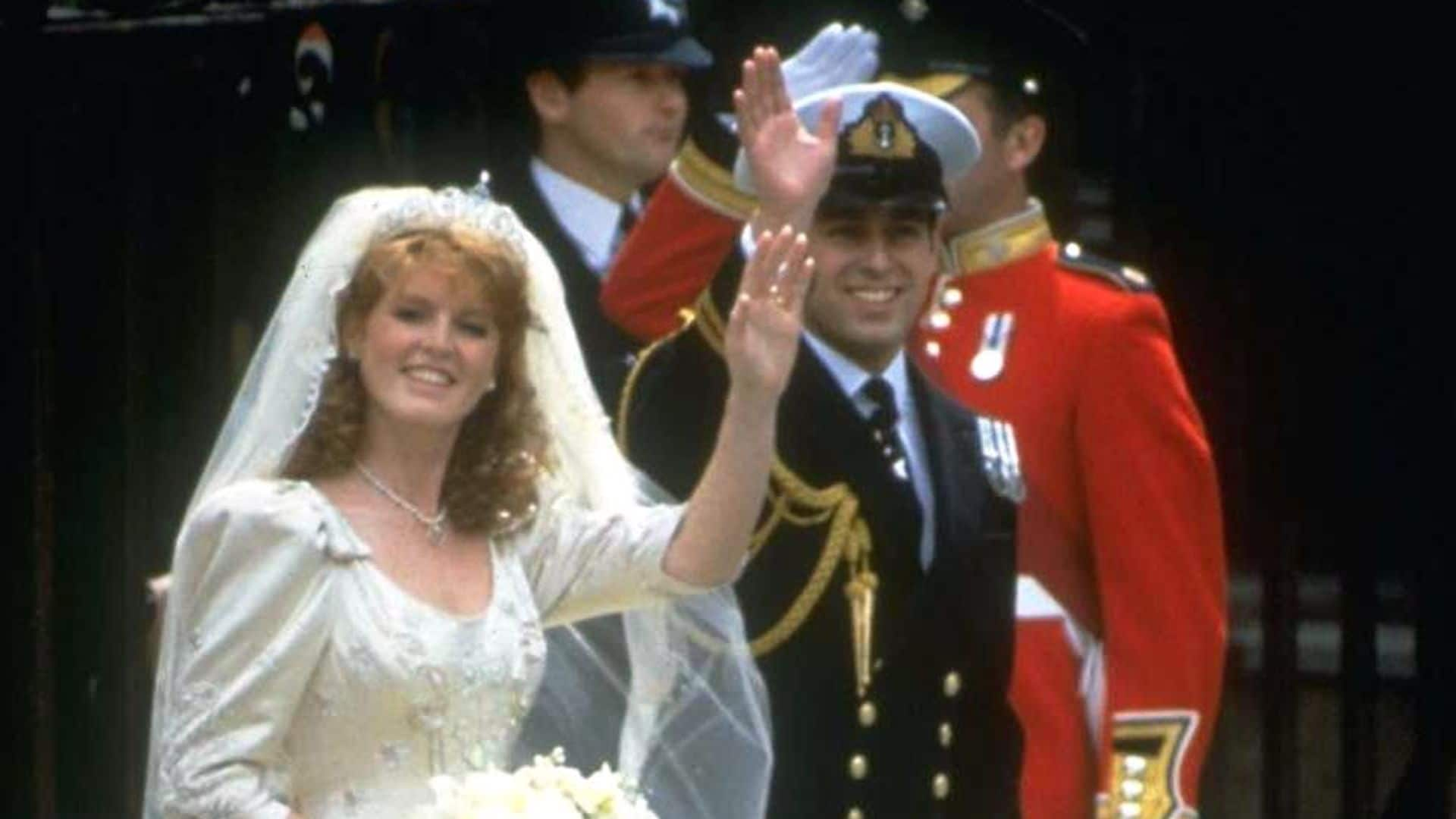 Prince Andrew, the Duke of York, and Sarah Ferguson wave outside of Buckingham Palace on their wedding day, London, England, July 23, 1986. (Photo by Hulton Archive/Getty Images) 