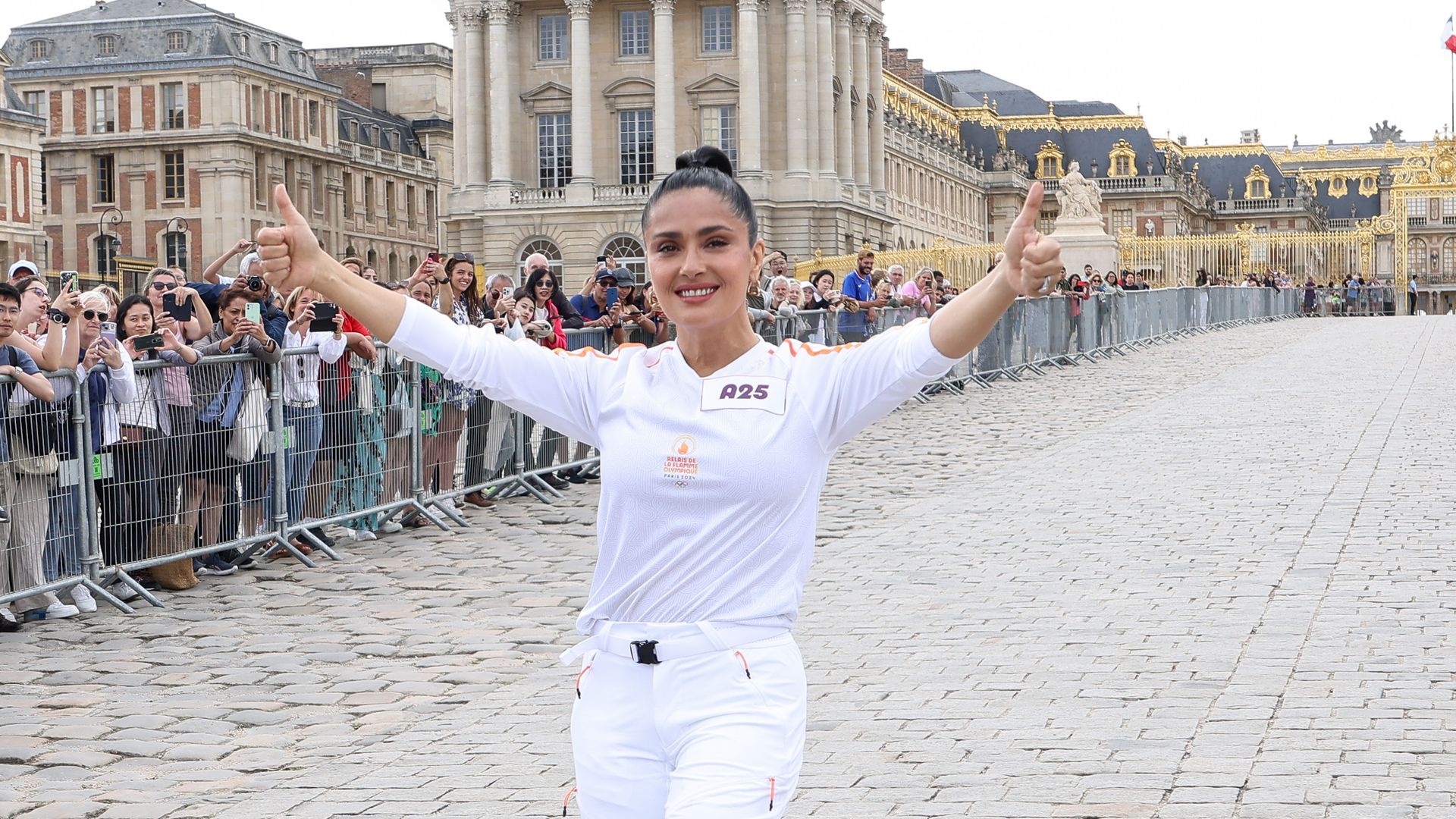Con orgullo, Salma Hayek porta la antorcha olímpica en el Palacio de Versalles