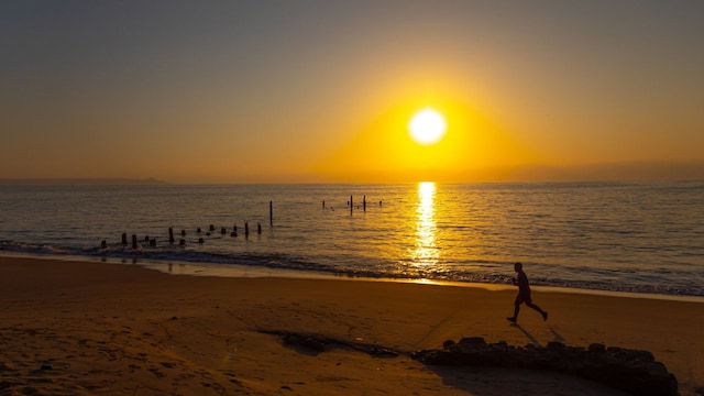 man running on the beach at sunset benguela province benguela angola