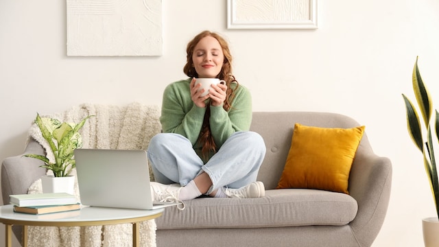 mujer relajada en el sofá tomando una infusión