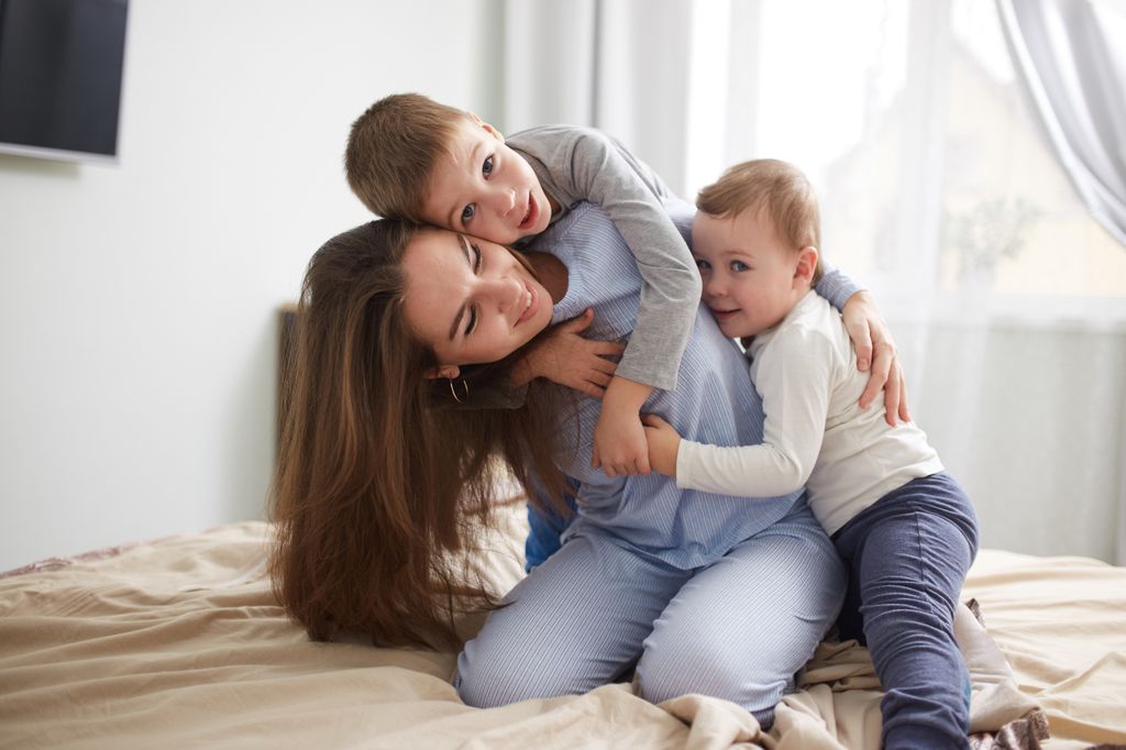 Madre jugando con sus dos hijos pequeños