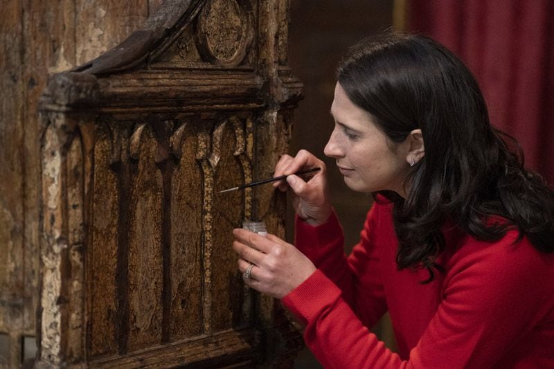 Una restauradora con la silla de coronación de los Reyes de Inglaterra