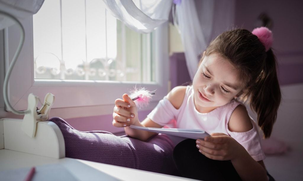 cute school girl writing her diary