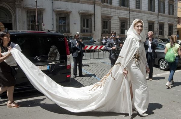 Sabine, joyera de profesión, sorprendió a su llegada con un espectacular vestido de incrustaciones doradas en forma de sol e impresionante cola y capucha diseñado por Schiaparelli
