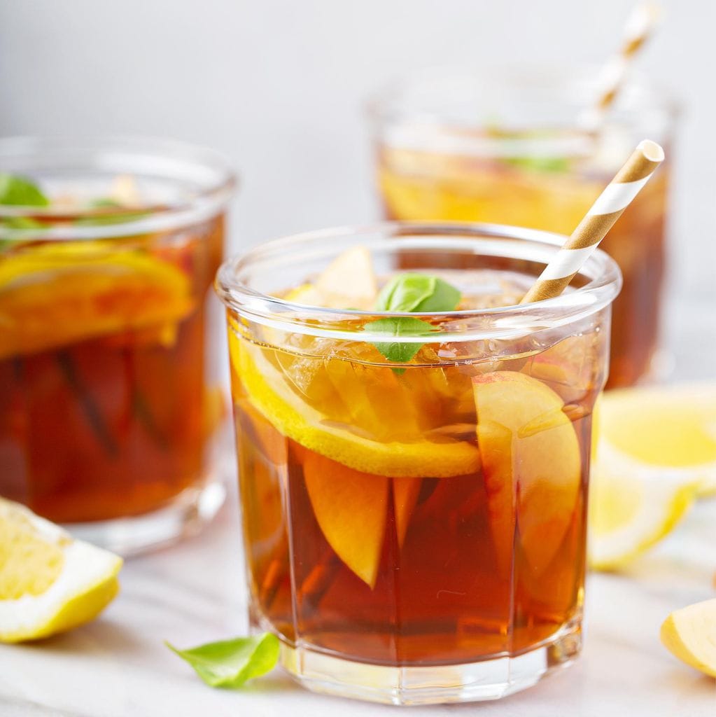 Peach and lemon sweet iced tea on a marble surface