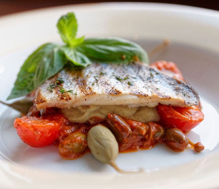 Lubina con berenjena, tomate y alcaparrones