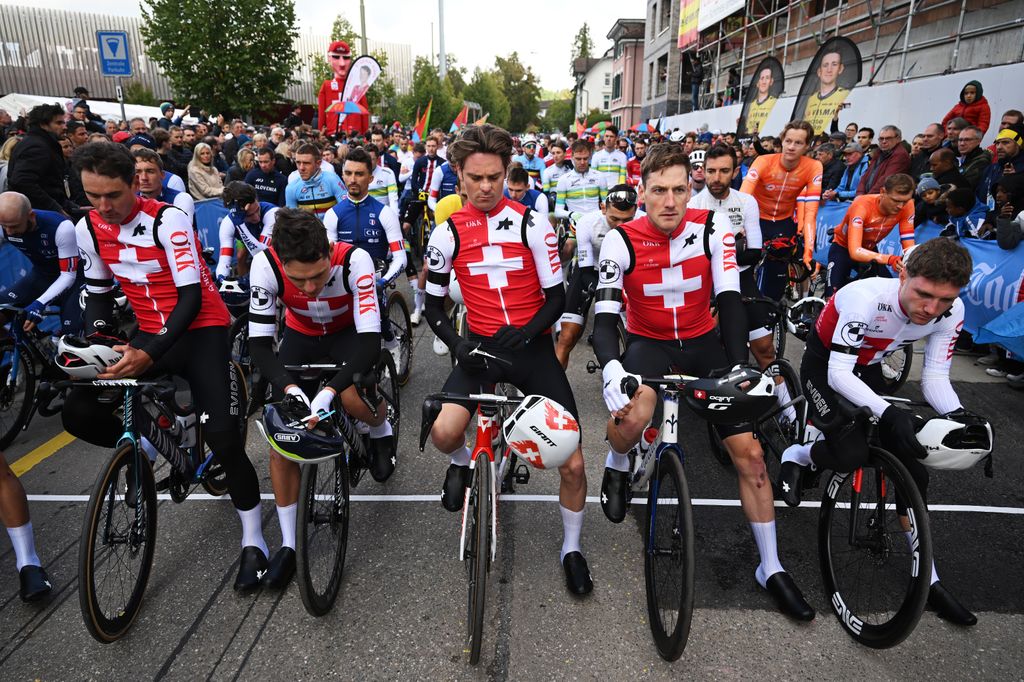 The men's platoon, led by the Swiss team, observes a minute of silence for Muriel Ferrer