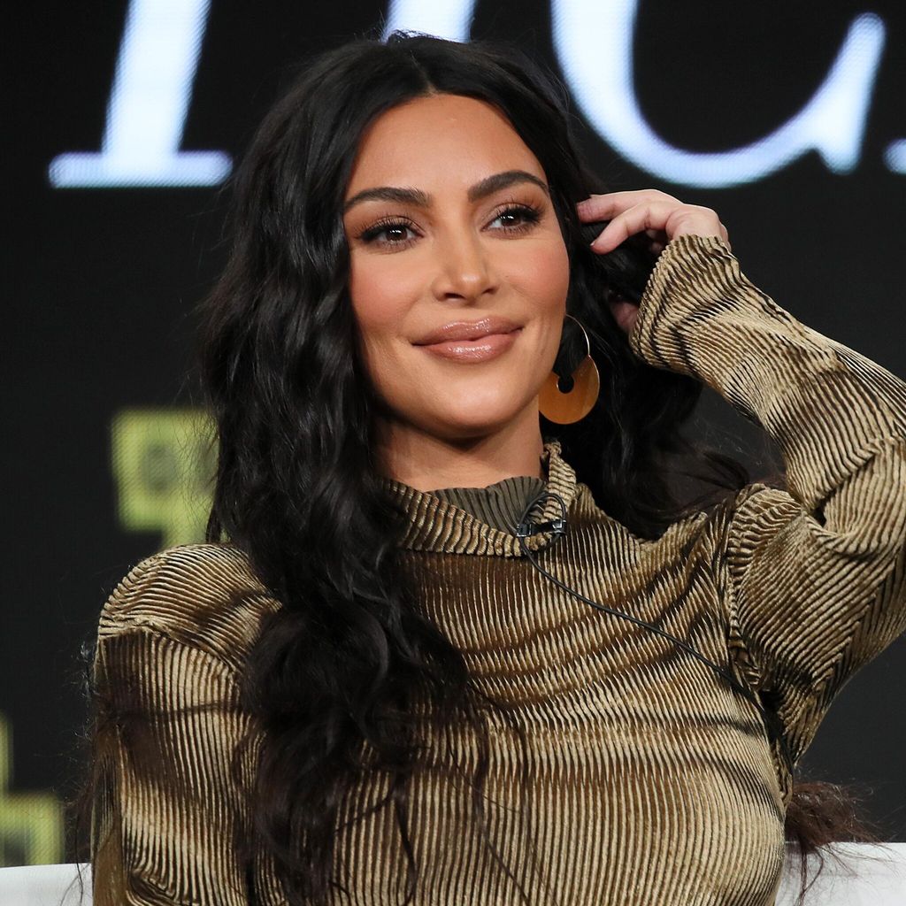 kim kardashian con cabello suelto ondas y raya en el medio