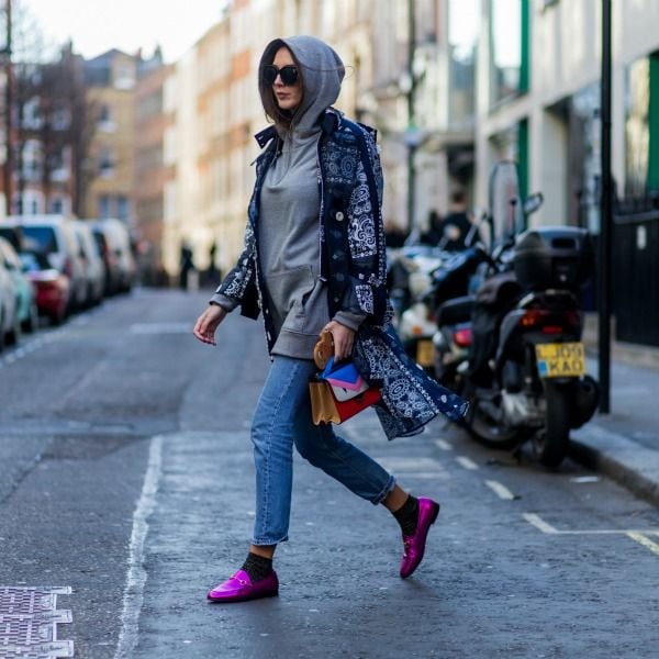 Sudadera canguro de algodón gris con vaqueros, náuticos metalizados en fucsia y bolso de mano de Fendi.
