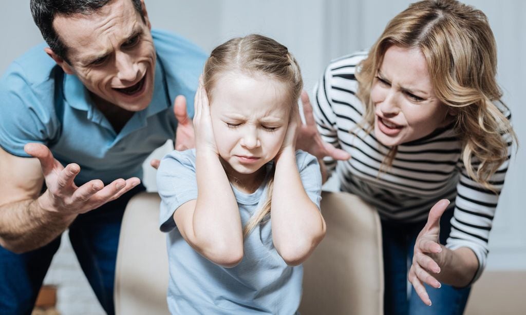 Unsmiling girl and her parents shouting at her