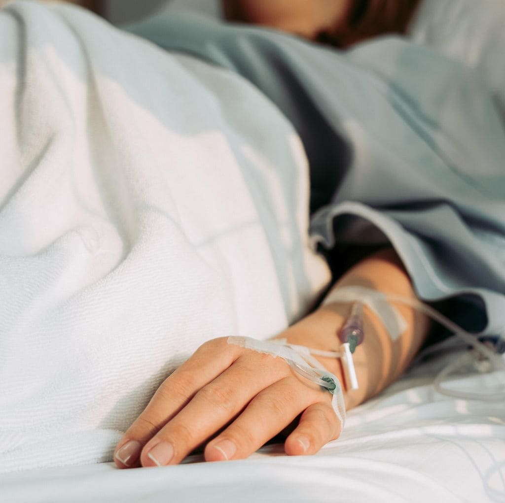 Asian woman lying sick in hospital.