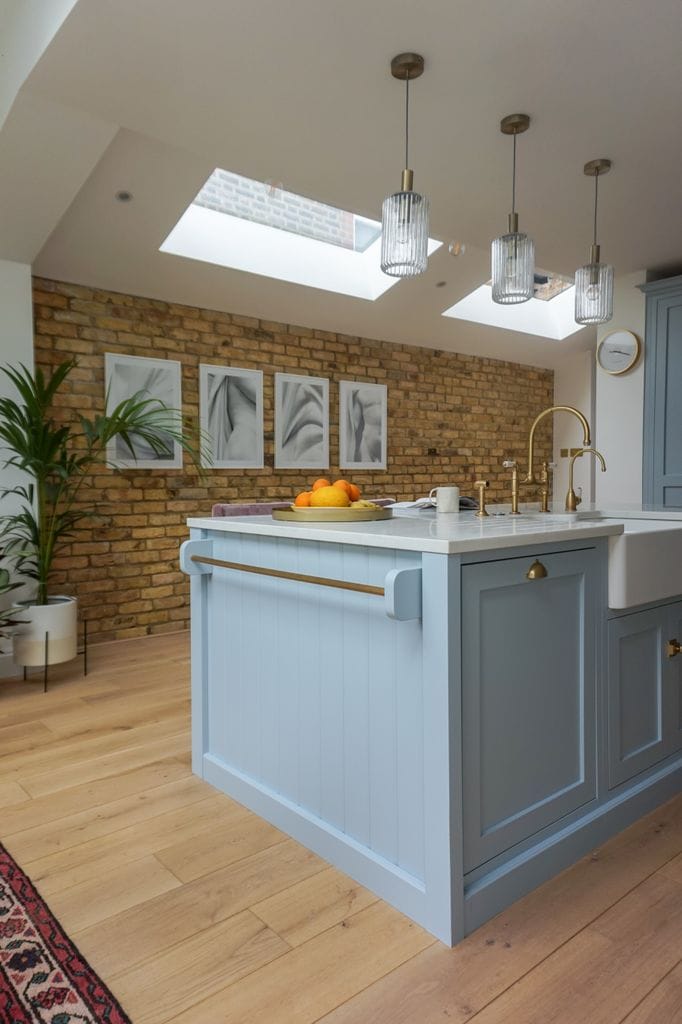 Classic kitchen with brick wall with blue furniture