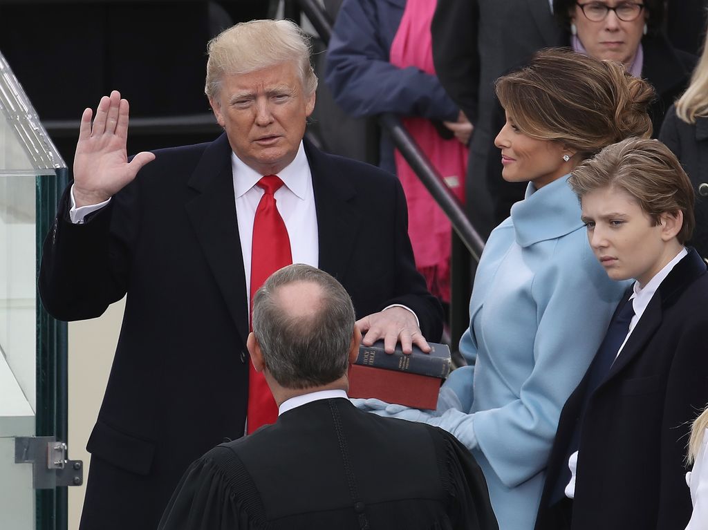 WASHINGTON, DC - JANUARY 20:  Supreme Court Justice John Roberts (2L) administers the oath of office to U.S. President Donald Trump (L) as his wife Melania Trump holds the Bible and son Barron Trump looks on, on the West Front of the U.S. Capitol on January 20, 2017 in Washington, DC. In today's inauguration ceremony Donald J. Trump becomes the 45th president of the United States.  (Photo by Drew Angerer/Getty Images)