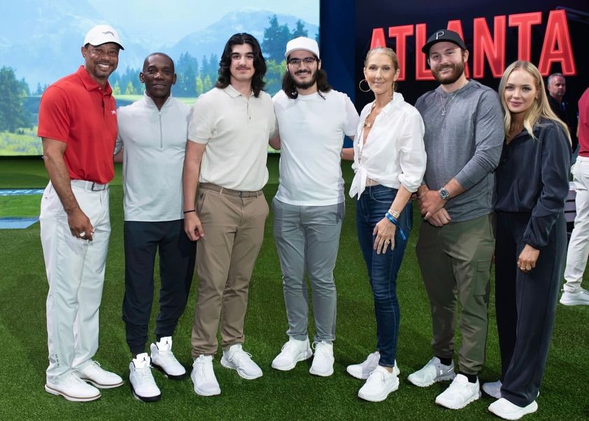 Celine and her three children pose with Tiger in the TGL golf tournament