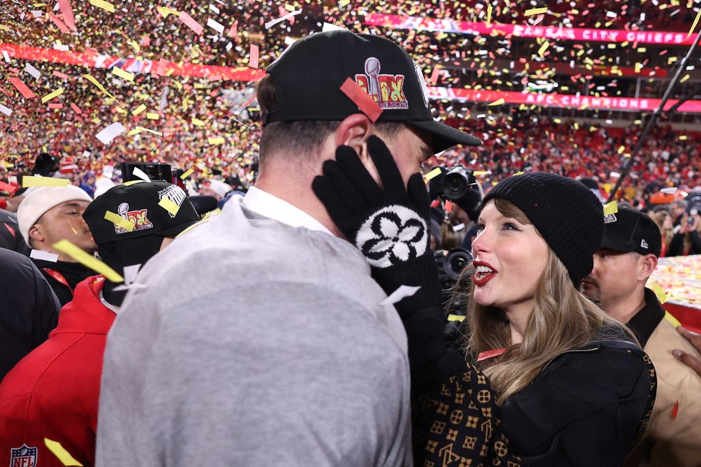 KANSAS CITY, MISSOURI - JANUARY 26: Taylor Swift celebrates with Travis Kelce #87 of the Kansas City Chiefs after defeating the Buffalo Bills 32-29 in the AFC Championship Game at GEHA Field at Arrowhead Stadium on January 26, 2025 in Kansas City, Missouri.  (Photo by Jamie Squire/Getty Images)