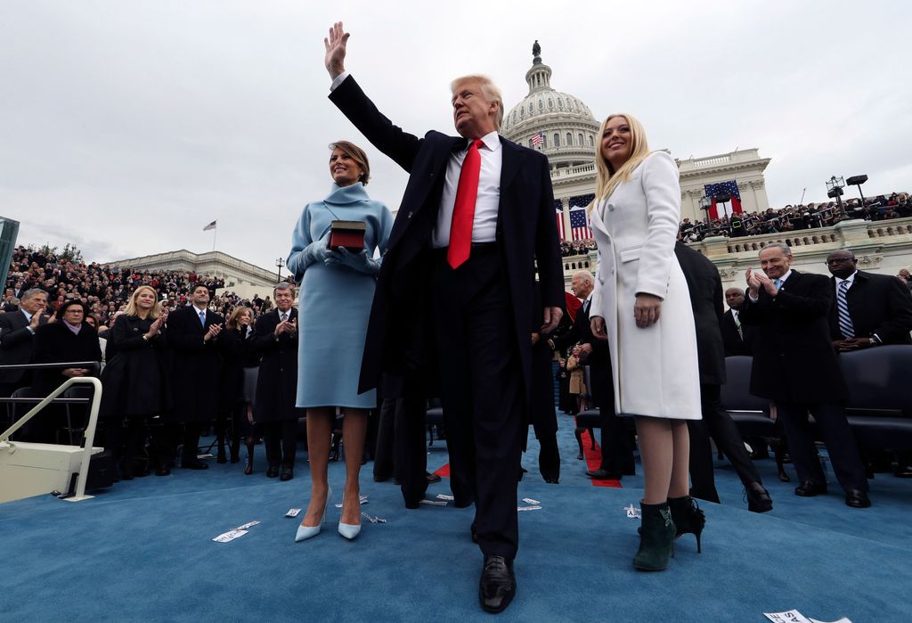 WASHINGTON, DC - JANUARY 20:  U.S. President Donald Trump acknowledges the audience after taking the oath of office as his wife Melania (L) and daughter Tiffany watch during inauguration ceremonies swearing in Trump as the 45th president of the United States on the West front of the U.S. Capitol in Washington, DC. January 20, 2017. (Photo by Jim Bourg - Pool/Getty Images)