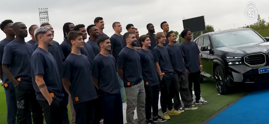 The Real Madrid squad poses with the model of their new car