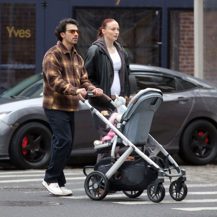 Joe Jonas and Sophie Turner walking their daughter