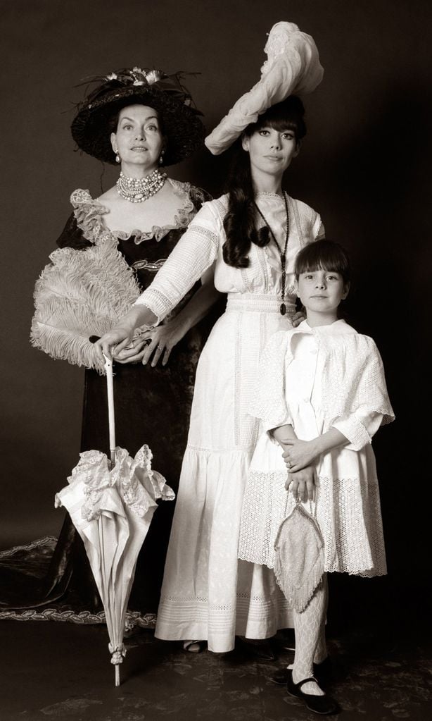 1960s THREE GENERATIONS WOMEN GRANDMOTHER MOTHER DAUGHTER POSED STANDING LOOKING AT CAMERA WEARING 1890s FASHION DRESSES (Photo by H. Armstrong Roberts/ClassicStock/Getty Images)