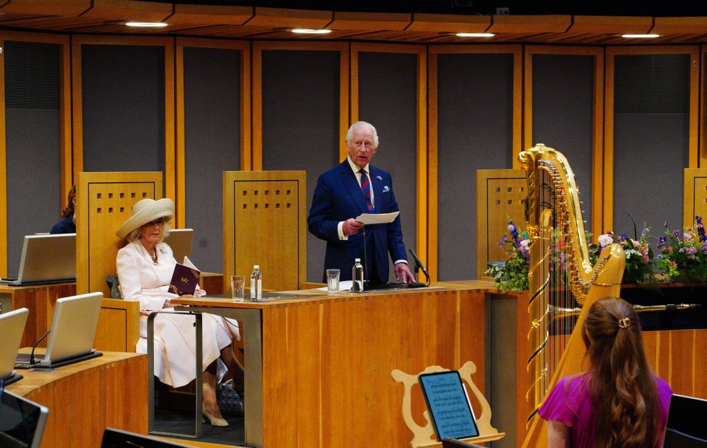 Carlos y Camilla, reyes británicos, en el Senedd, el parlamento de Gales por su 25 aniversario el pasado 11 de julio. A los pies de la reina Camilla se puede ver el icónico bolso de Diana de Gales