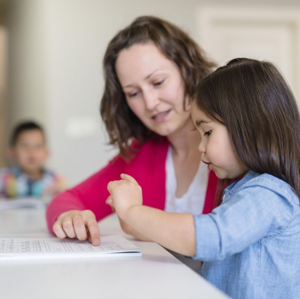 Mom homeschooling her young children