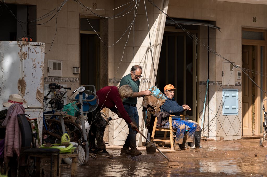 VALENCIA, SPAIN - OCTOBER 30: People try to drain mud from their houses after catastrophic flash floods due to heavy rain in Utiel municipality of Valencia, Spain on October 30, 2024. Catastrophic flooding has left at least 72 people dead, Spain's public broadcaster RTVE reported. (Photo by Diego Radames/Anadolu via Getty Images)