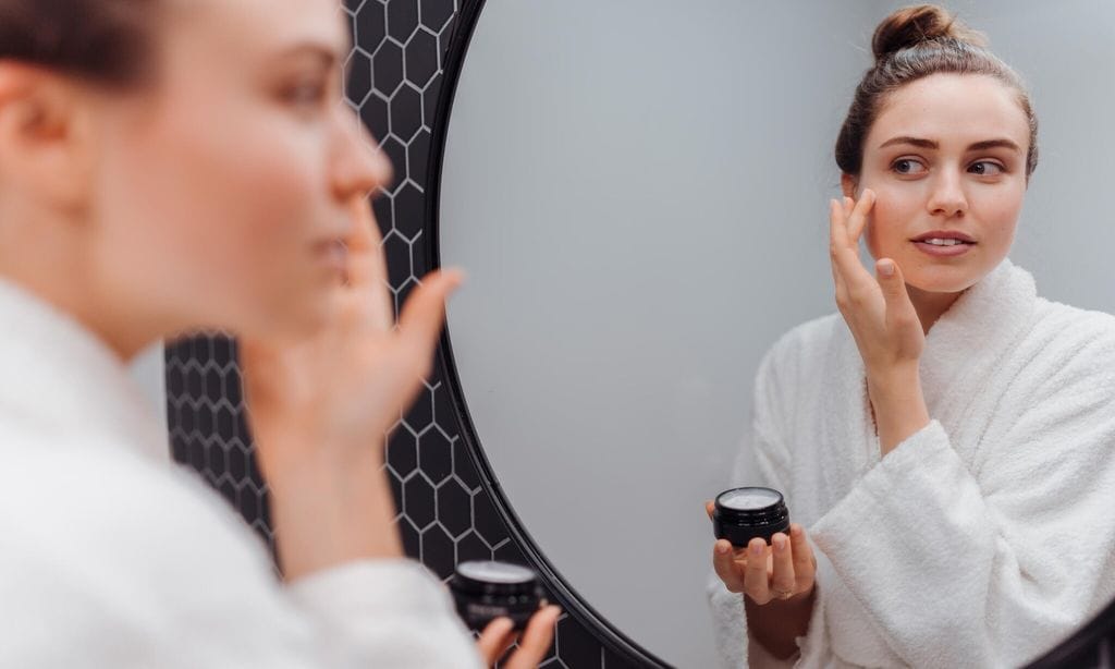 Young woman in bathrobe, concept of skincare routine