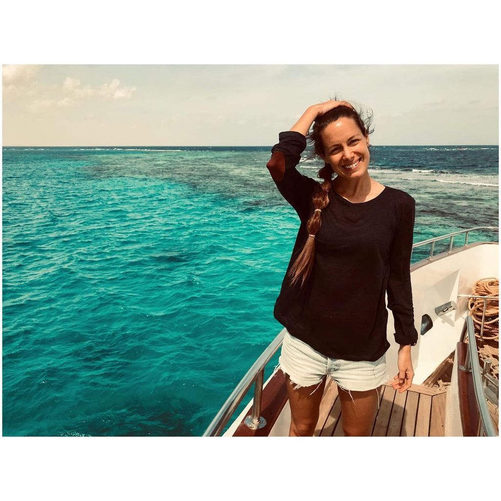 Laura Madrueño smiling on a boat with the sea in the background