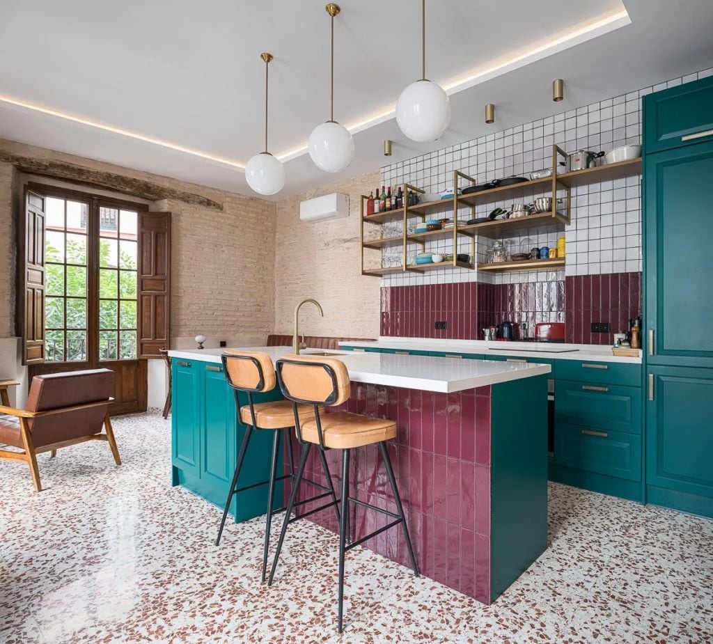 Colorful kitchen with brick walls. 