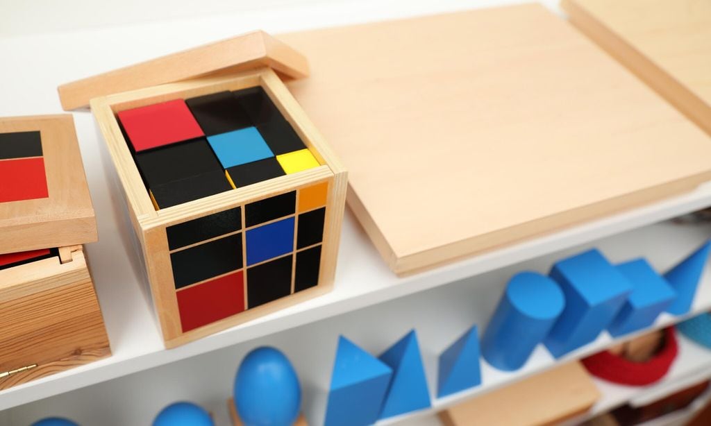 set of wooden geometrical objects and other montessori toys on shelves