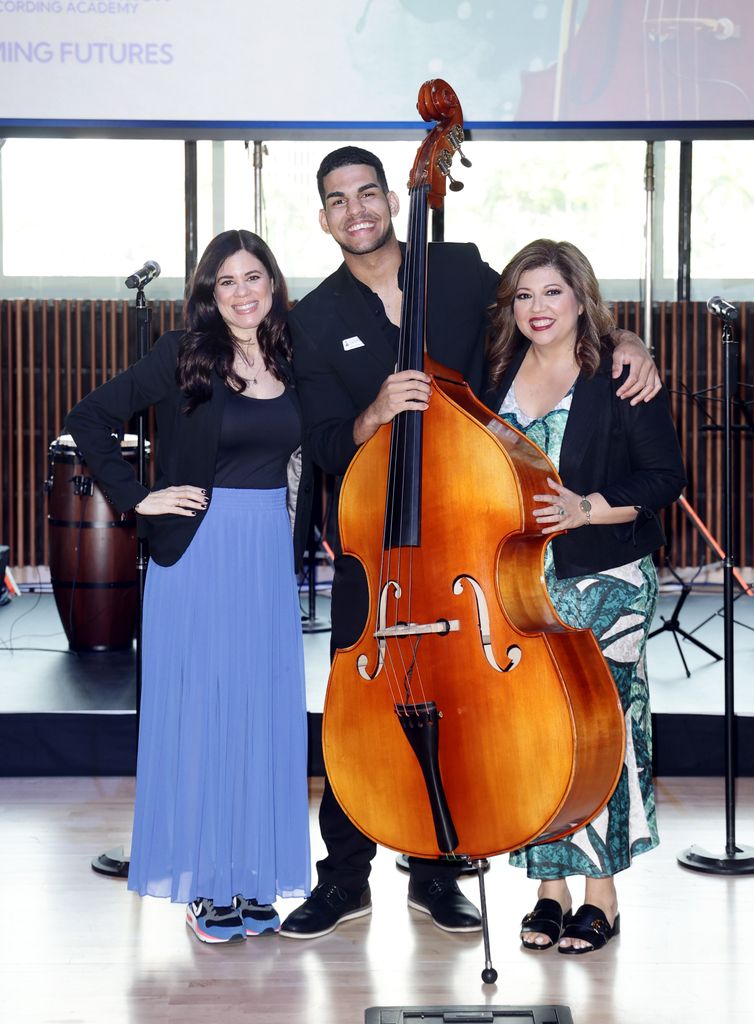 CORAL GABLES, FLORIDA - AUGUST 07: Nannette Velez, Leo Luna Roblejo, SebastiÃ¡n Yatra Scholarship Recipient and Rocky Egusquiza, Executive Director for the Latin GRAMMY Cultural Foundation, pose on stage at the LGCF SebastiÃ¡n Yatra Scholarship Ceremony on August 07, 2024 in Coral Gables, Florida. (Photo by John Parra/Getty Images for The Latin Recording Academy)