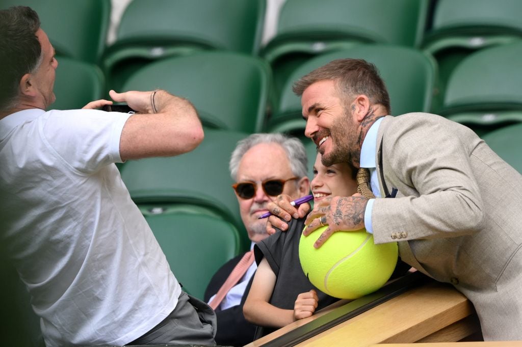 David Beckham haciéndose una foto con un niño en Wimbledon