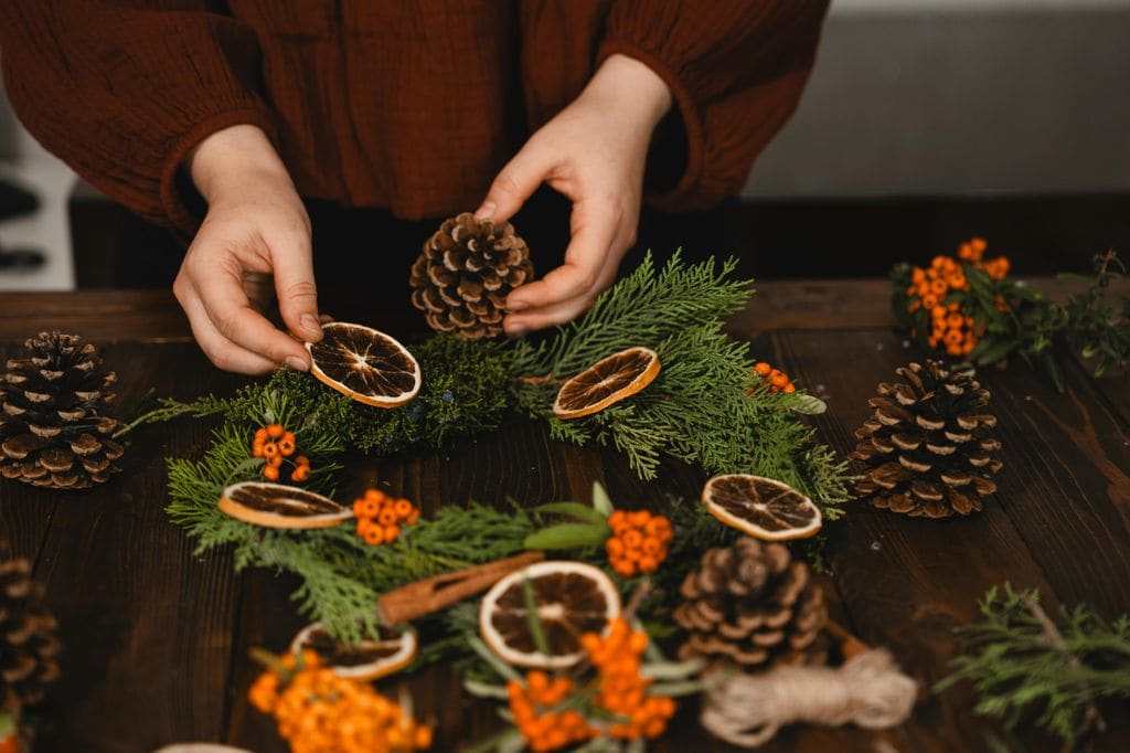 Corona de Navidad con piñas y naranja seca