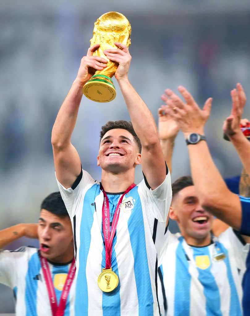 Julian Alvarez of Argentina raises the trophy after winning the FIFA World Cup Qatar 2022 Final match between Argentina and France at Lusail Stadium on December 18, 2022 in Lusail City, Qatar