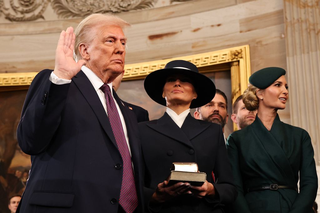 WASHINGTON, DC - JANUARY 20: Donald Trump takes the oath of office as his wife Melania and his children look on during inauguration ceremonies in the Rotunda of the U.S. Capitol on January 20, 2025 in Washington, DC. Donald Trump takes office for his second term as the 47th president of the United States. (Photo by Chip Somodevilla/Getty Images)