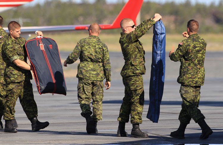 Soldados canadienses se esmeran en que el equipaje de la Duquesa de Cambridge llegue a su destino impecable, en julio 2011 en Yellowknife, la capital de los Territorios del Noroeste en Canadá
