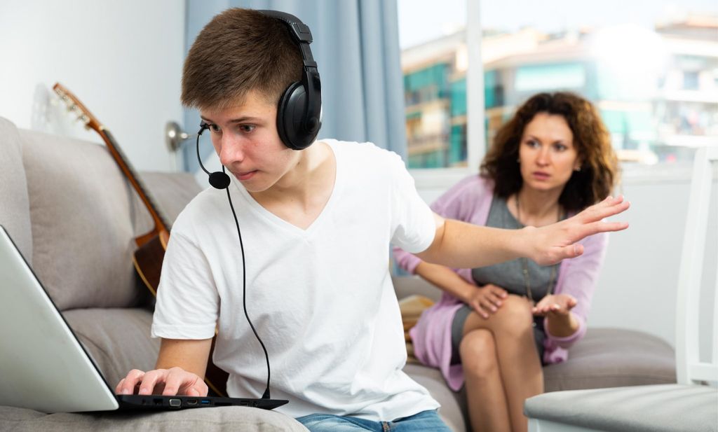 Teenager boy addicted with laptop