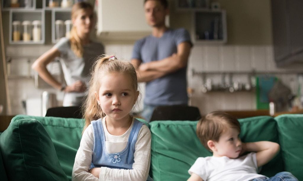 Kid girl upset, offended or bored ignoring parents and brother