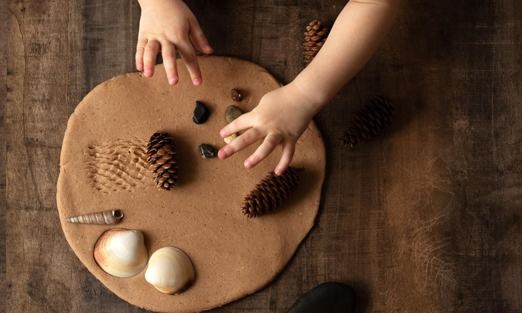 Modeling with salt dough on the kitchen table. Natural materials for the game, the natural composition of the product. Creative development of children in the period of self-isolation