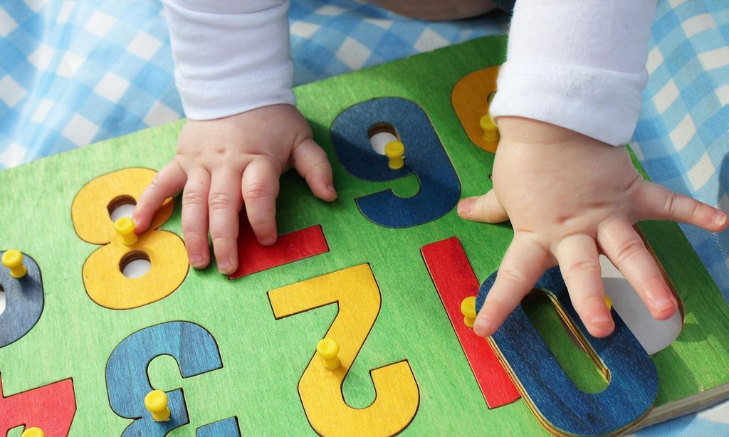 child playing with a number puzzle