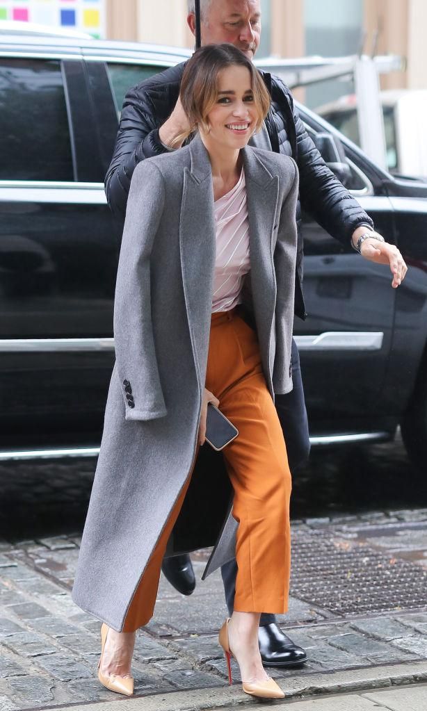 Emilia Clark usando un long coat y pantalones slouchy