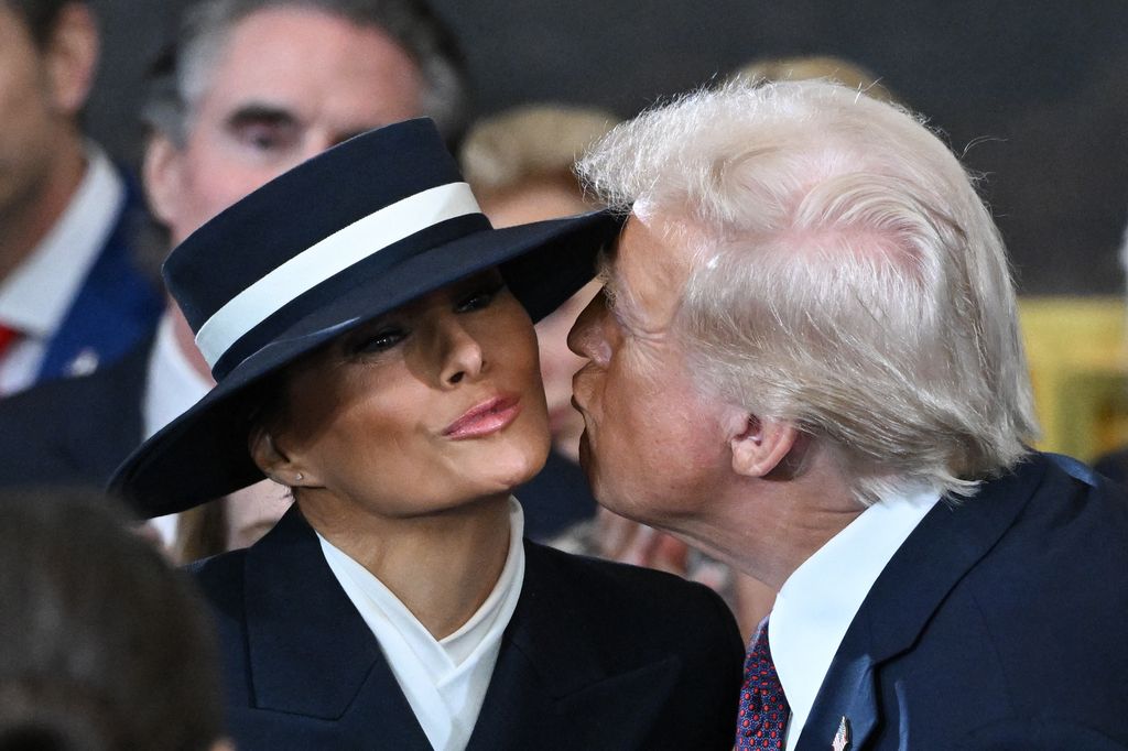 US President-elect Donald Trump kisses Melania Trump as he arrives for the inauguration ceremony before he is sworn in as the 47th US President in the US Capitol Rotunda in Washington, DC, on January 20, 2025. (Photo by SAUL LOEB / POOL / AFP) (Photo by SAUL LOEB/POOL/AFP via Getty Images)