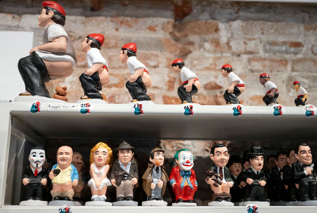 Catalan typical clay figurines, called "caganers" (poopies), are displayed at a shop in Barcelona on December 12, 2023. Statuettes of well-known people defecating are a strong Christmas tradition in Catalonia, dating back to the 18th century as Catalans hide 'caganers' in Christmas Nativity scenes and invite friends to find them. (Photo by Josep LAGO / AFP) (Photo by JOSEP LAGO/AFP via Getty Images)