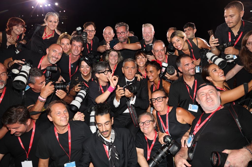 VENICE, ITALY - SEPTEMBER 01: George Cloney poses with photographers as he attends the "Wolfs" red carpet during the 81st Venice International Film Festival on September 01, 2024 in Venice, Italy. (Photo by Pascal Le Segretain/Getty Images)