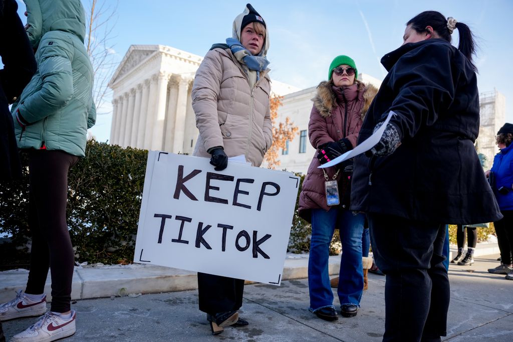 WASHINGTON, DC - JANUARY 10: (L-R) Sarah Baus of Charleston, S.C., holds a sign that reads "Keep TikTok" as she and other content creators Sallye Miley of Jackson, Mississippi, and Callie Goodwin of Columbia, S.C., stand outside the U.S. Supreme Court Building as the court hears oral arguments on whether to overturn or delay a law that could lead to a ban of TikTok in the U.S., on January 10, 2025 in Washington, DC. The future of the popular social media platform is at stake as the Supreme Court hears arguments on a law set to take effect the day before Inauguration Day that would force their China-based parent company to cut ties with TikTok due to national security concerns. (Photo by Andrew Harnik/Getty Images)