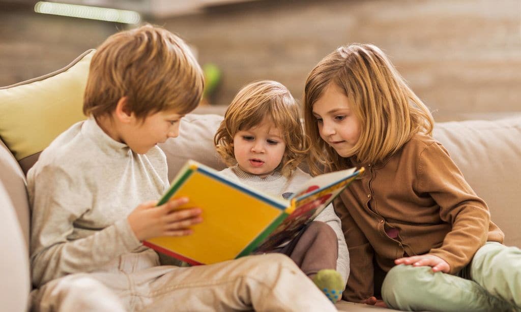 children reading picture book at home 