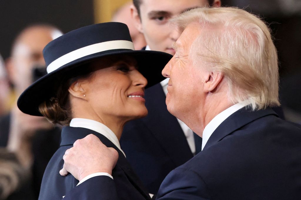 WASHINGTON, DC - JANUARY 20: U.S. President Donald Trump and First Lady Melania Trump embrace during inauguration ceremonies in the U.S. Capitol Rotunda on January 20, 2025 in Washington, DC. Donald Trump takes office for his second term as the 47th president of the United States. (Photo by Kevin Lamarque - Pool/Getty Images)