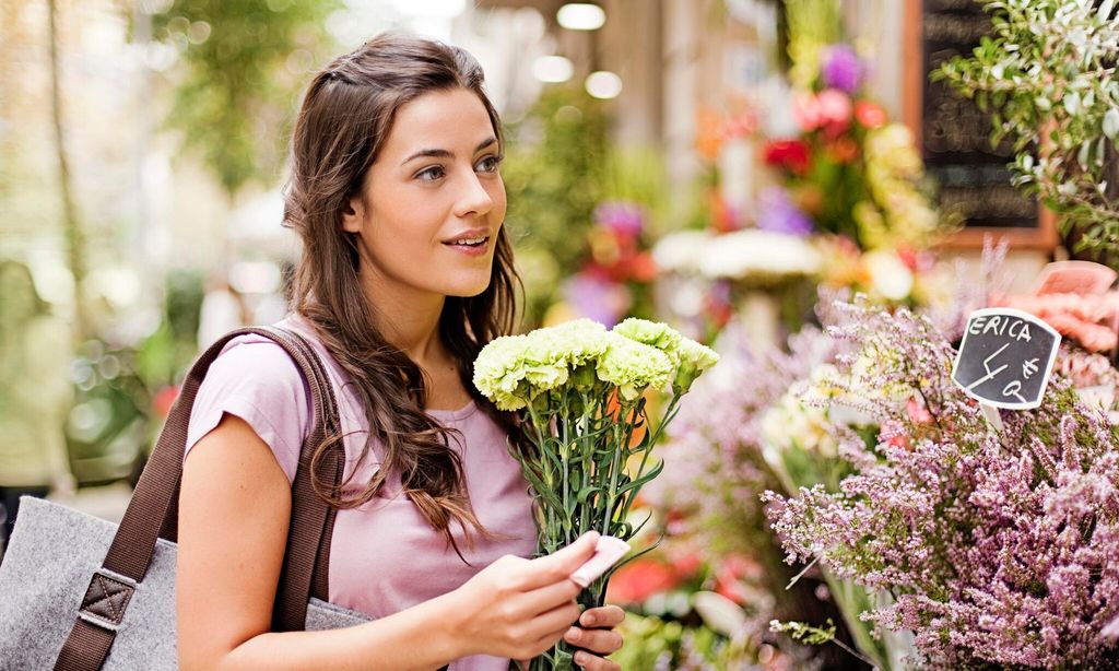 Young women buying flowers at market