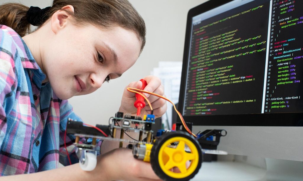 Female Pupil Building Robotic Car In Science Lesson